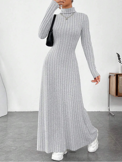 Woman wearing Vohran ribbed high-neck knit maxi dress with long sleeves and high neckline.