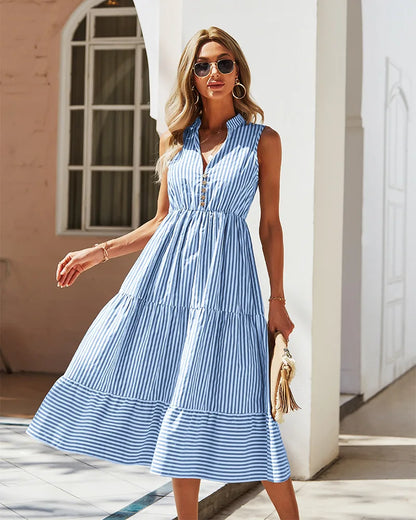 Model wearing a sleeveless striped midi shirt dress with buttons and tiered skirt, available in green and blue stripes.