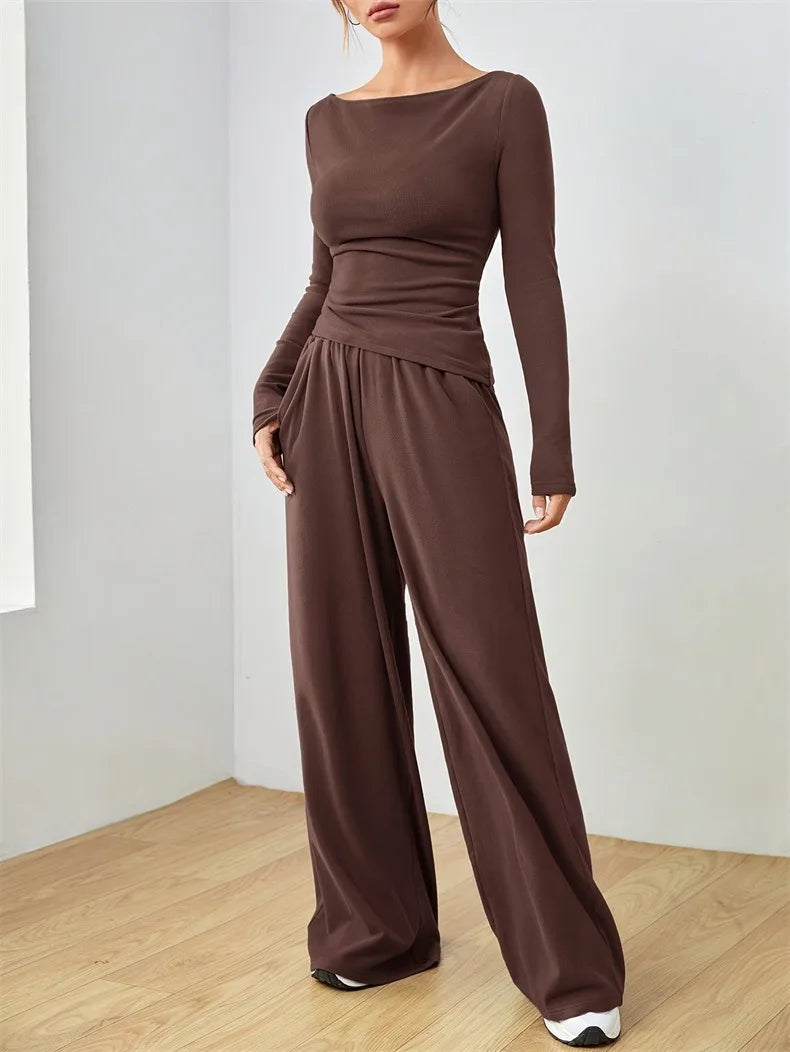 Two-piece co-ord with long-sleeve boat-neck jersey top and wide-leg trousers on model