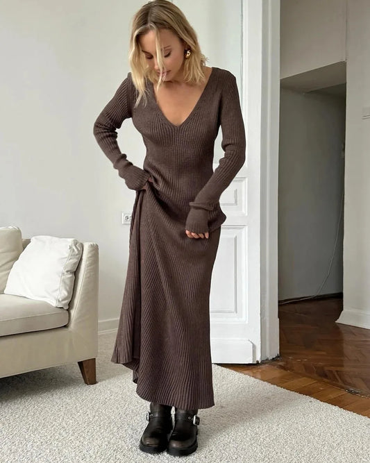 Woman wearing Vohran knitted V-neck A-line midi dress with long sleeves, elegant and structured silhouette.