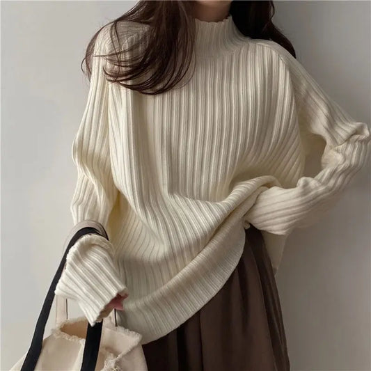 Loose-fit turtleneck knit sweater with long sleeves and ribbed details