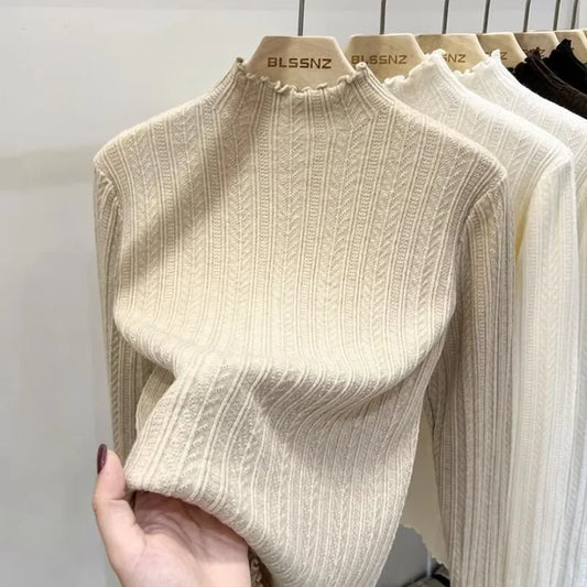 Soft ribbed mock-neck knit top with wavy-edge details and long sleeves
