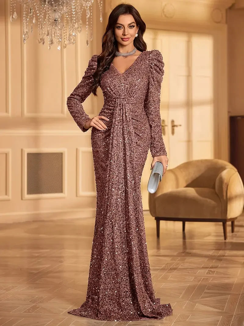 Woman wearing a rosé sequin full-length evening gown with structured shoulders and gathered waist in an elegant indoor setting.