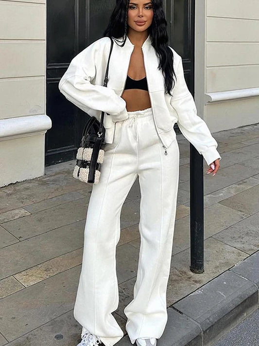 Woman in off-white zip-up sweatshirt with matching straight-leg joggers, VOHRAN two-piece athleisure set
